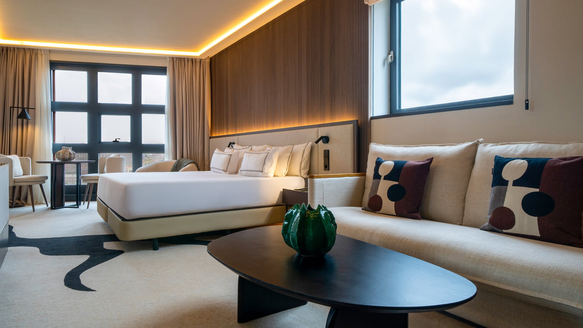 a room with a bed and couches