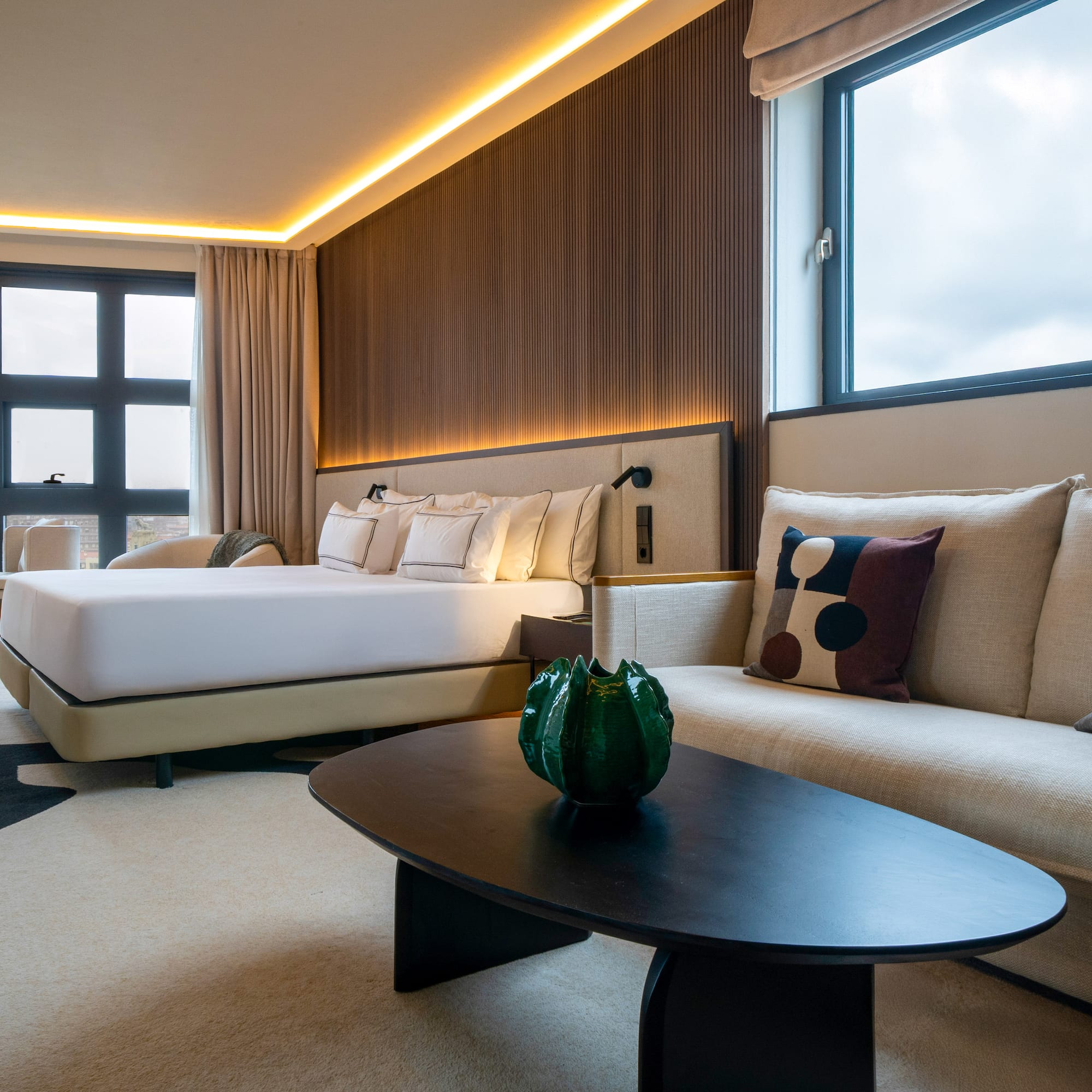 a room with a bed and couches