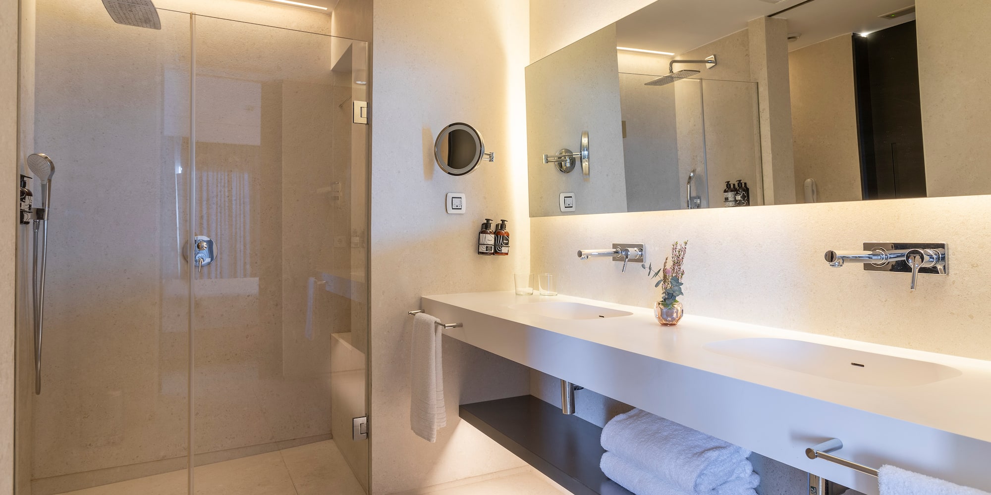 a bathroom with a glass shower and a sink