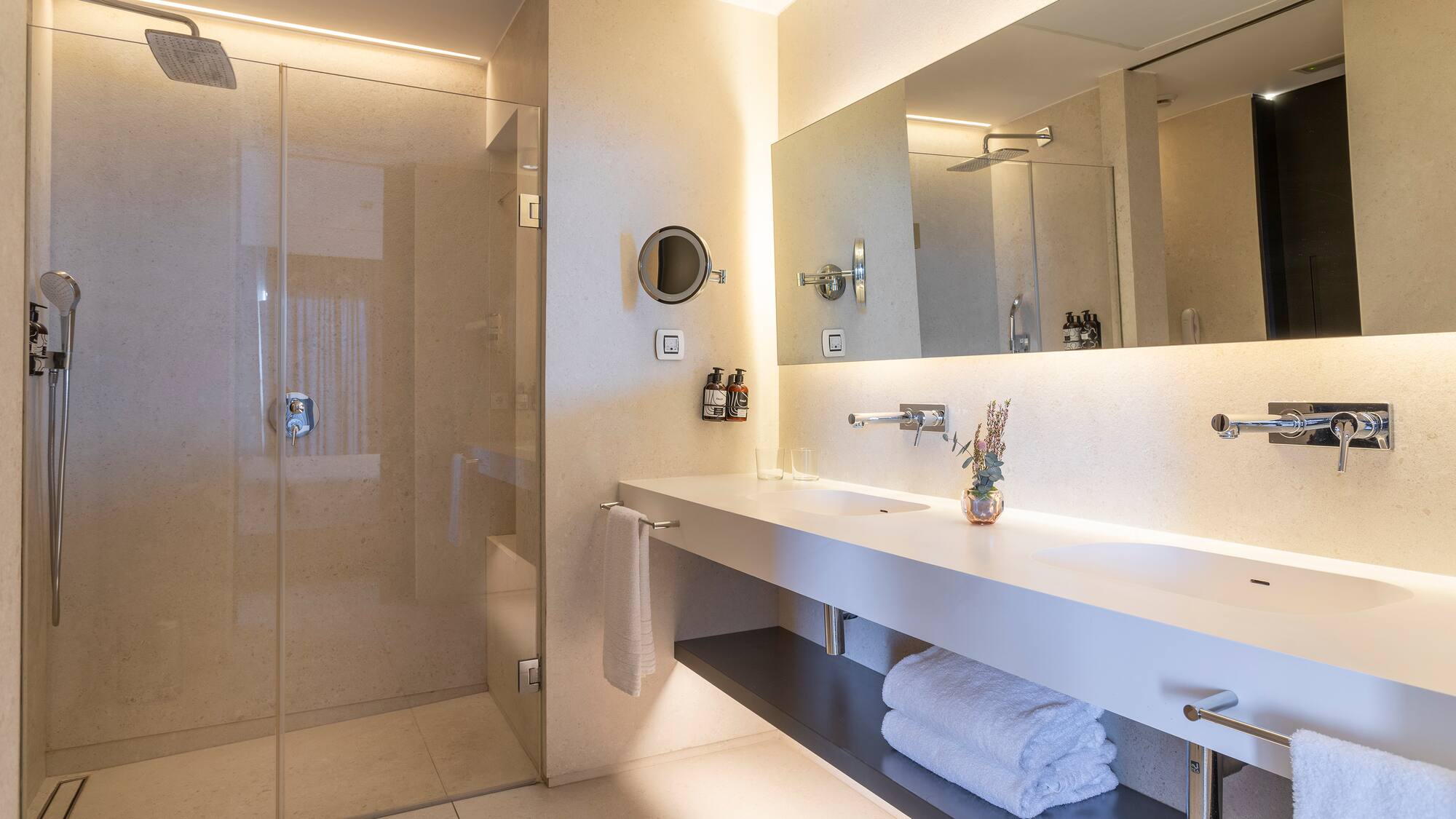 a bathroom with a glass shower and a sink