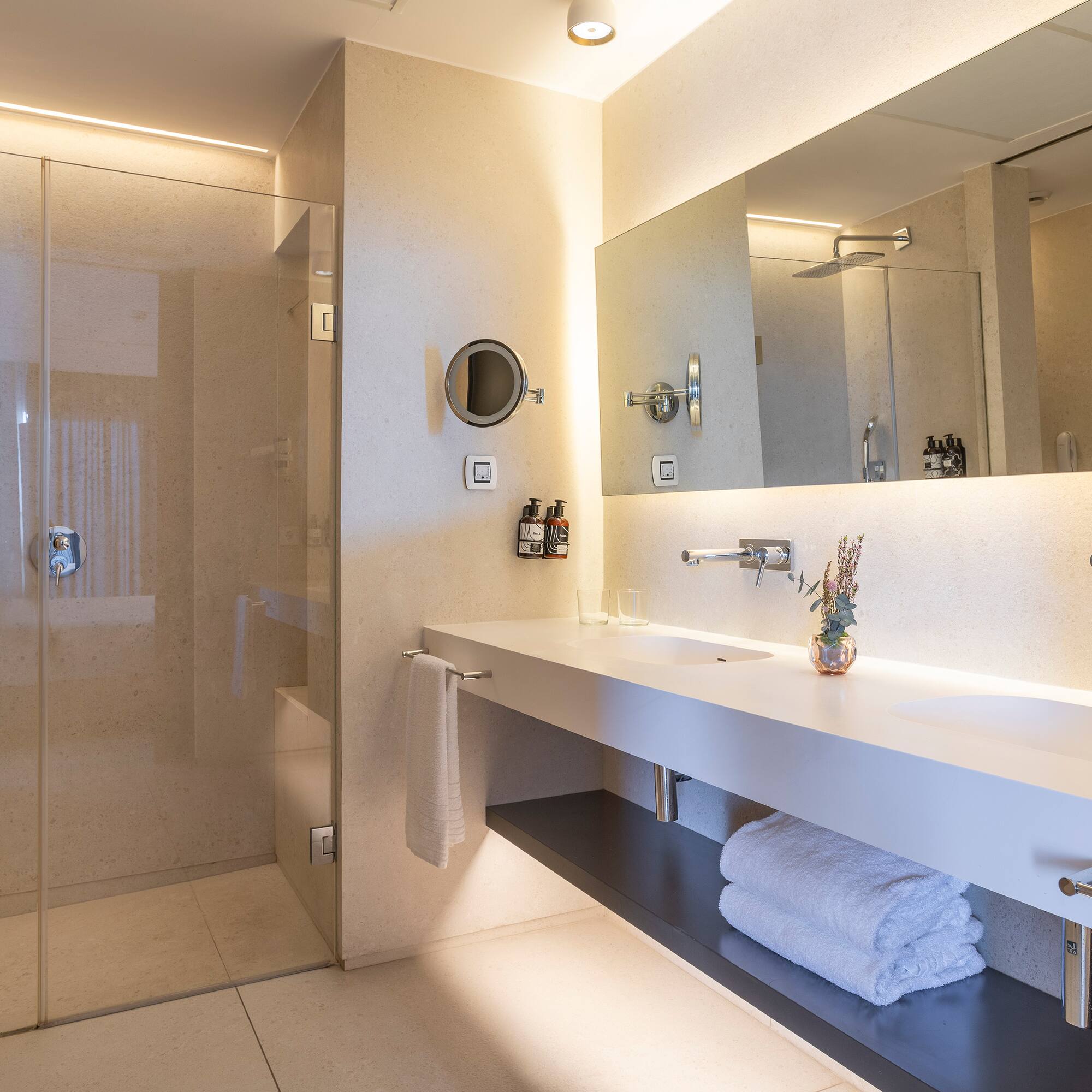 a bathroom with a glass shower and a sink