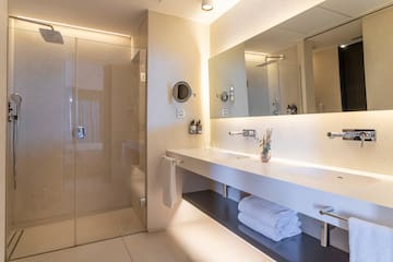 a bathroom with a glass shower and a sink