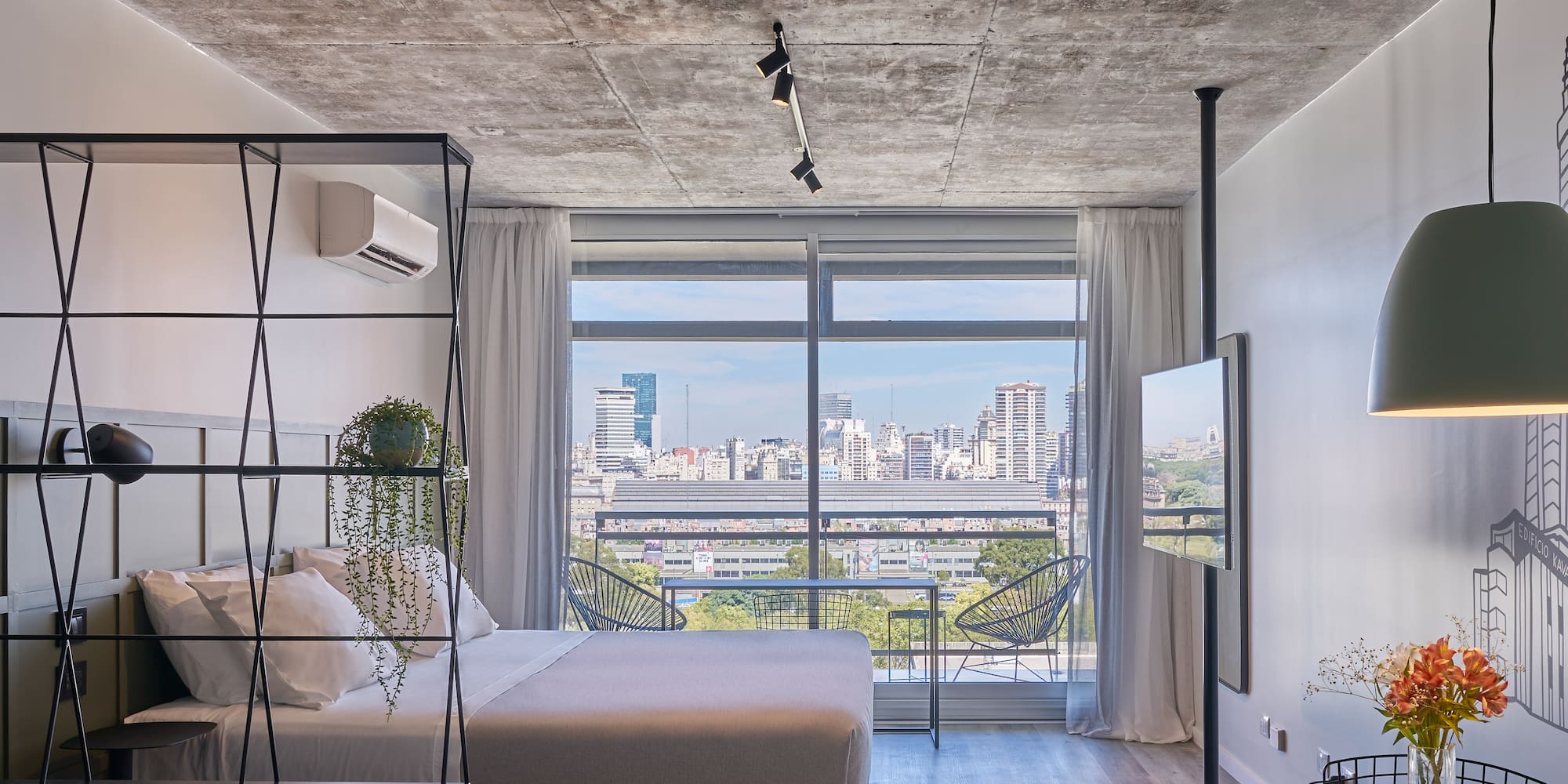 a bedroom with a view of a city
