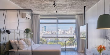 a bedroom with a view of a city