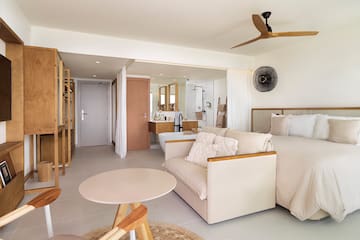a room with a bed and a sink and a bathtub