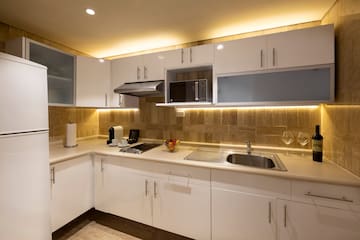 a kitchen with white cabinets and a sink