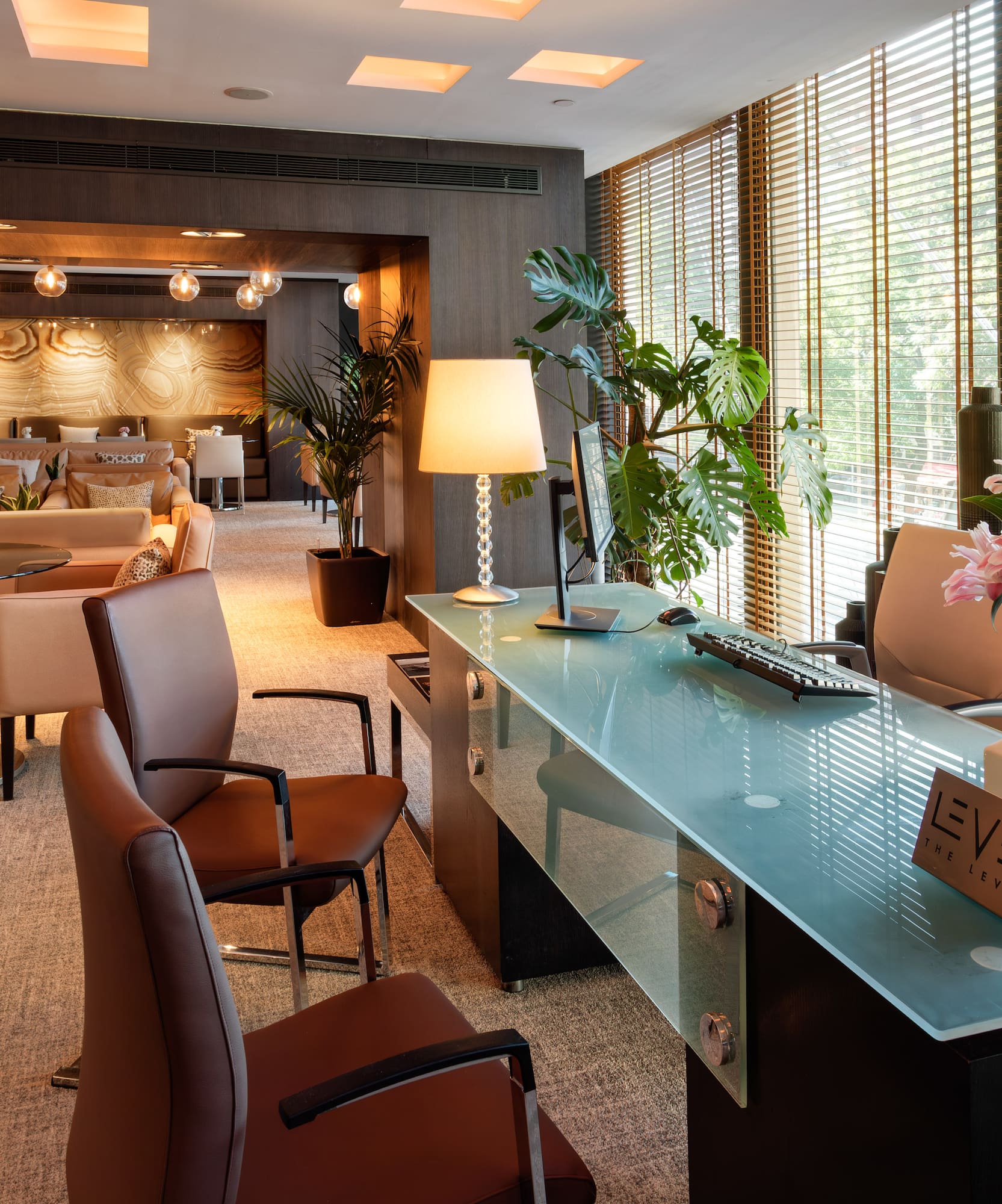 a room with a glass table and chairs