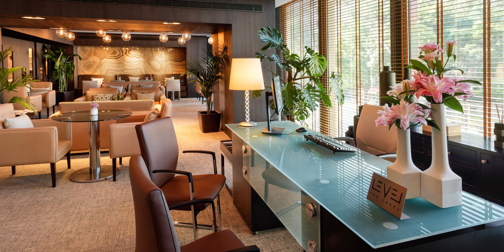 a room with a glass table and chairs