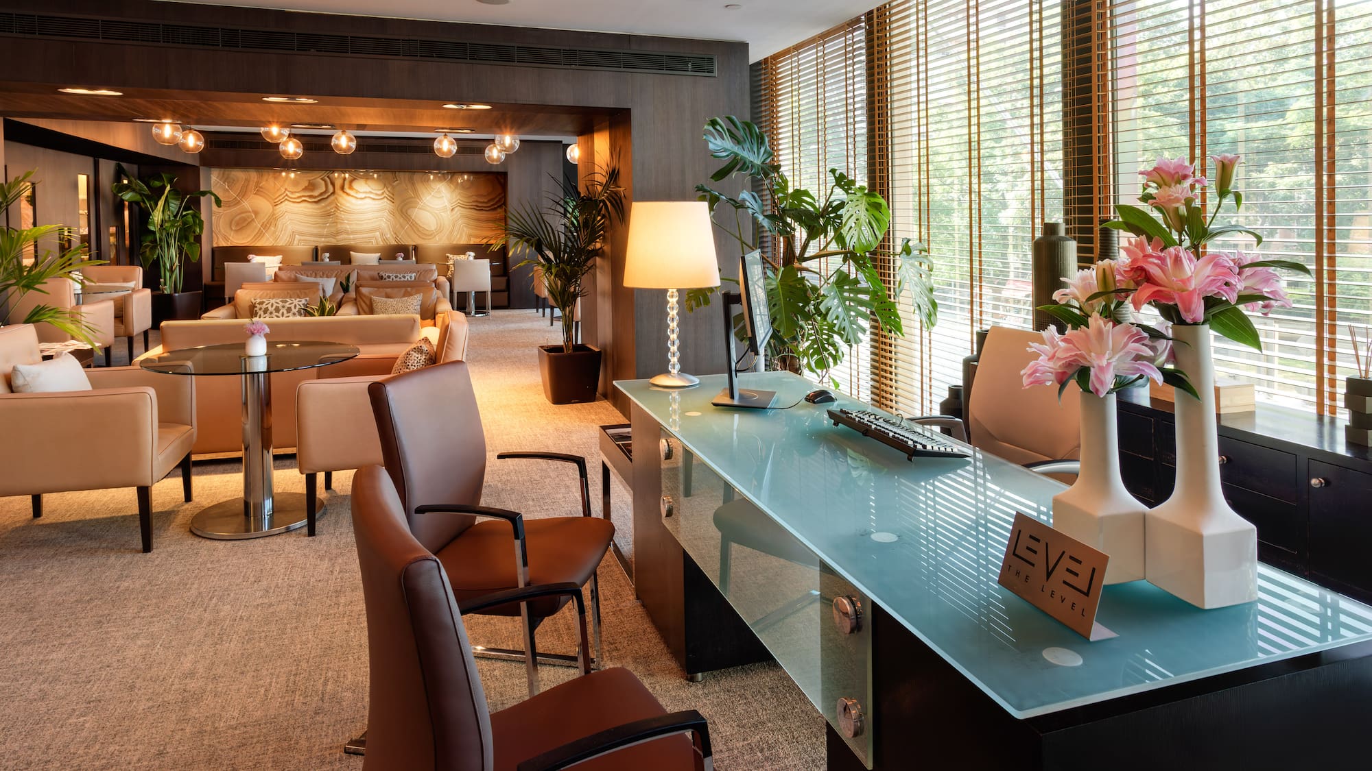 a room with a glass table and chairs