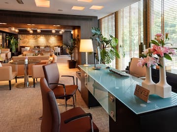 a room with a glass table and chairs