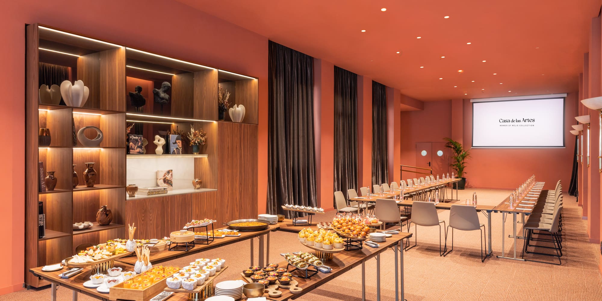 a room with tables of food and chairs