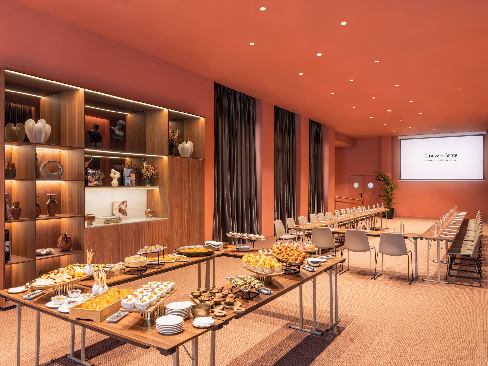 a room with tables of food and chairs