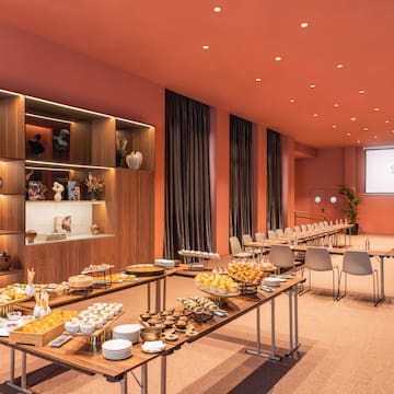 a room with tables of food and chairs
