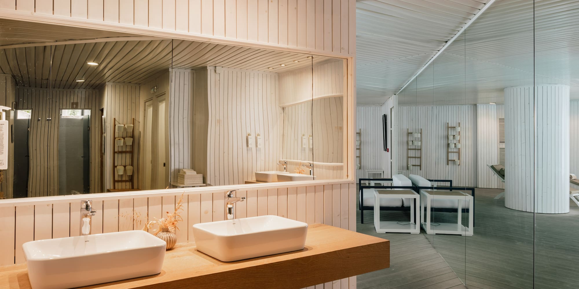 a bathroom with a large mirror and sinks