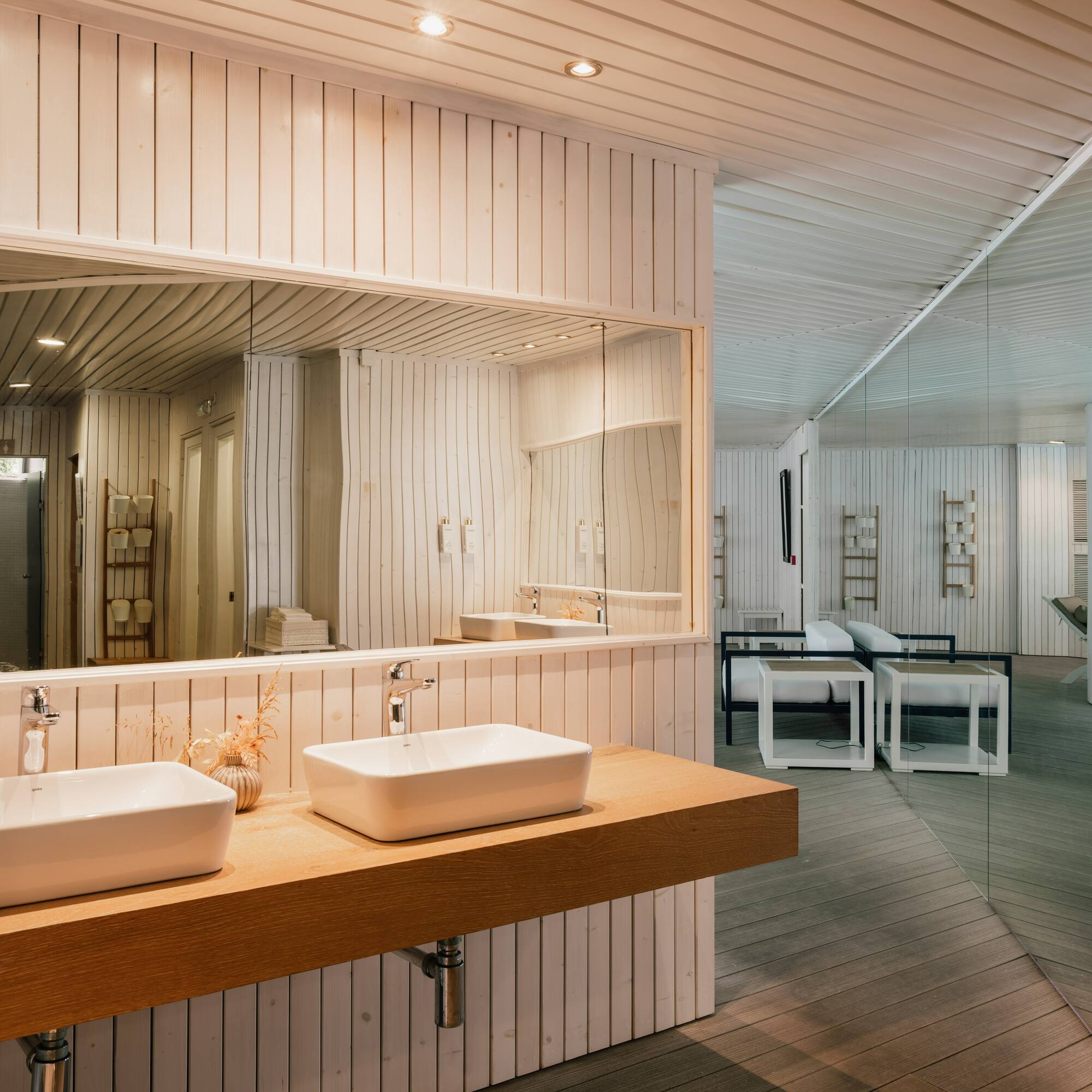 a bathroom with a large mirror and sinks