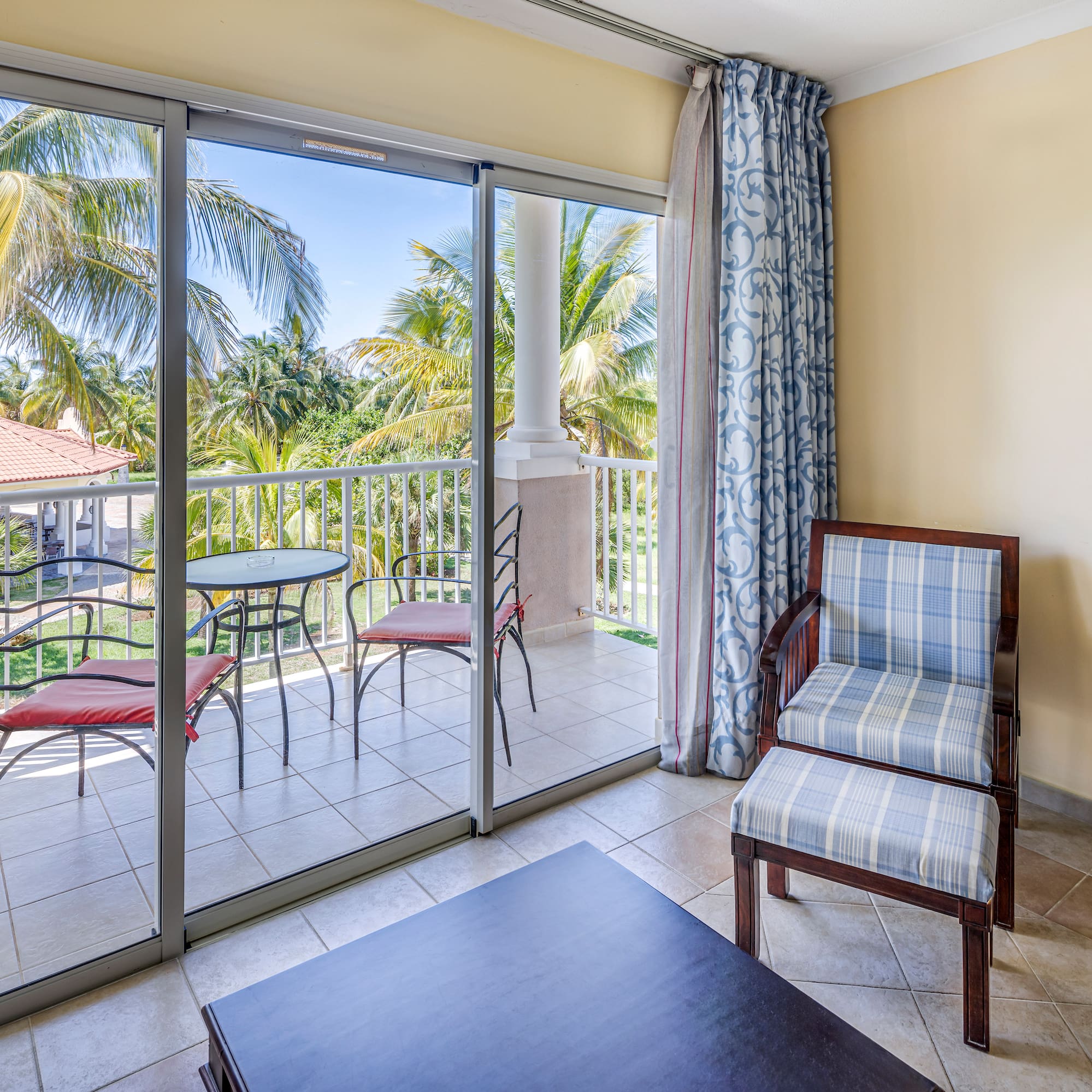 a room with glass doors and chairs