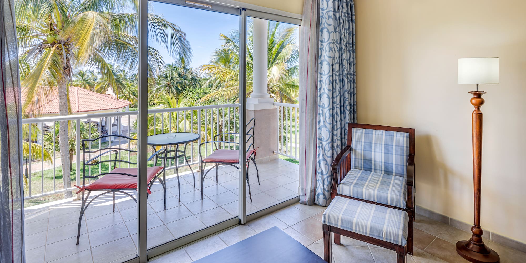 a room with glass doors and chairs