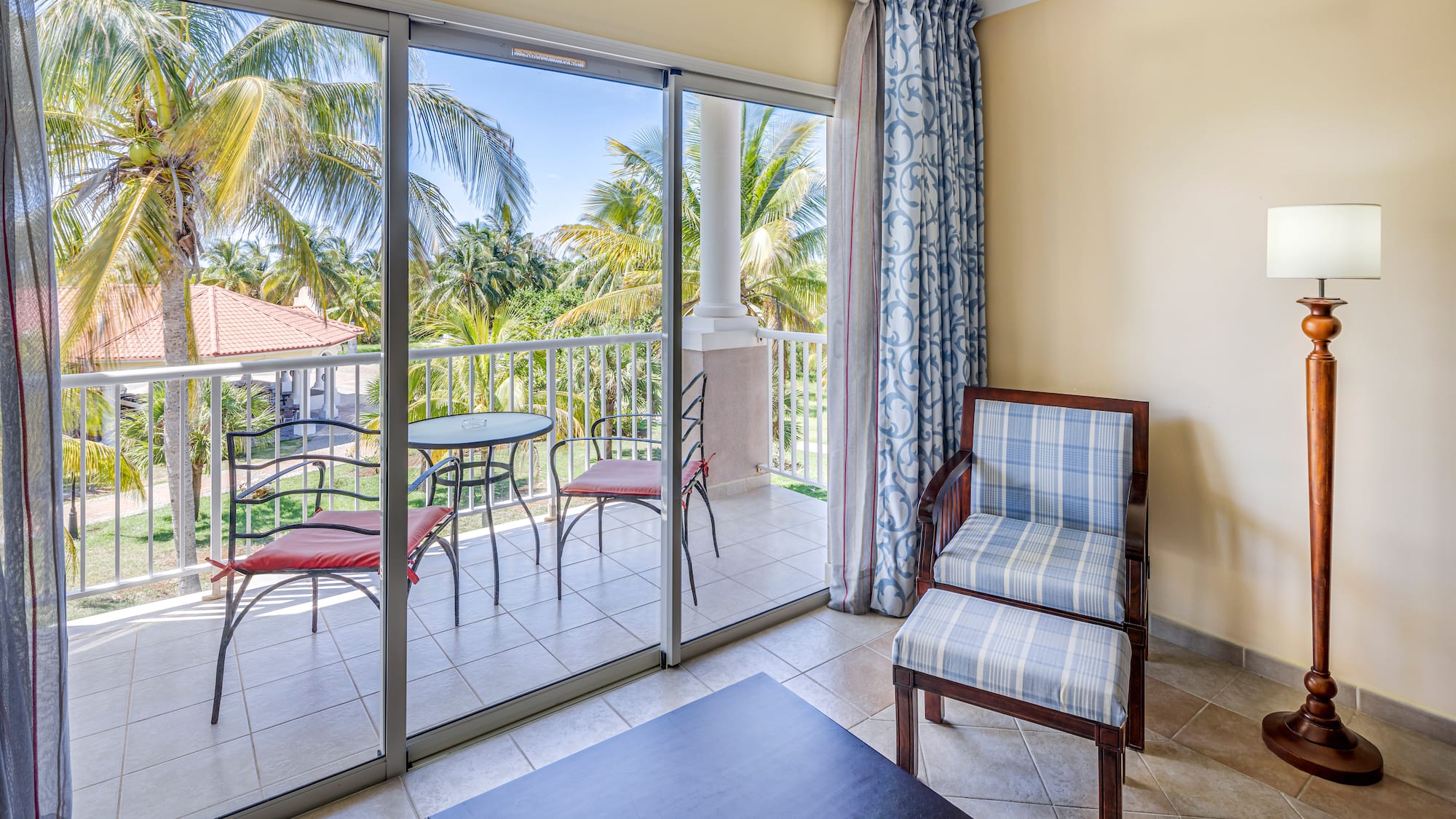 a room with glass doors and chairs