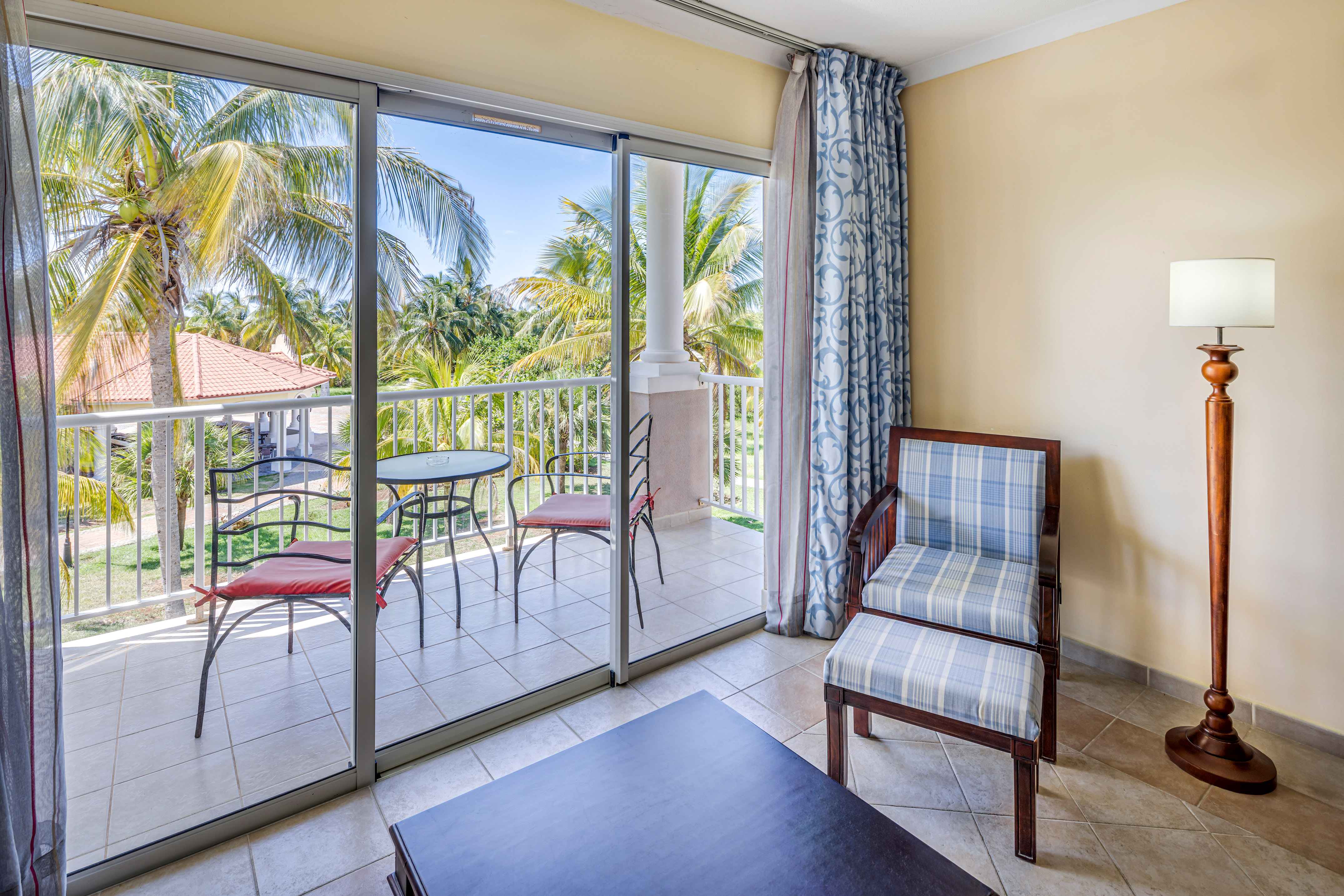 a room with glass doors and chairs