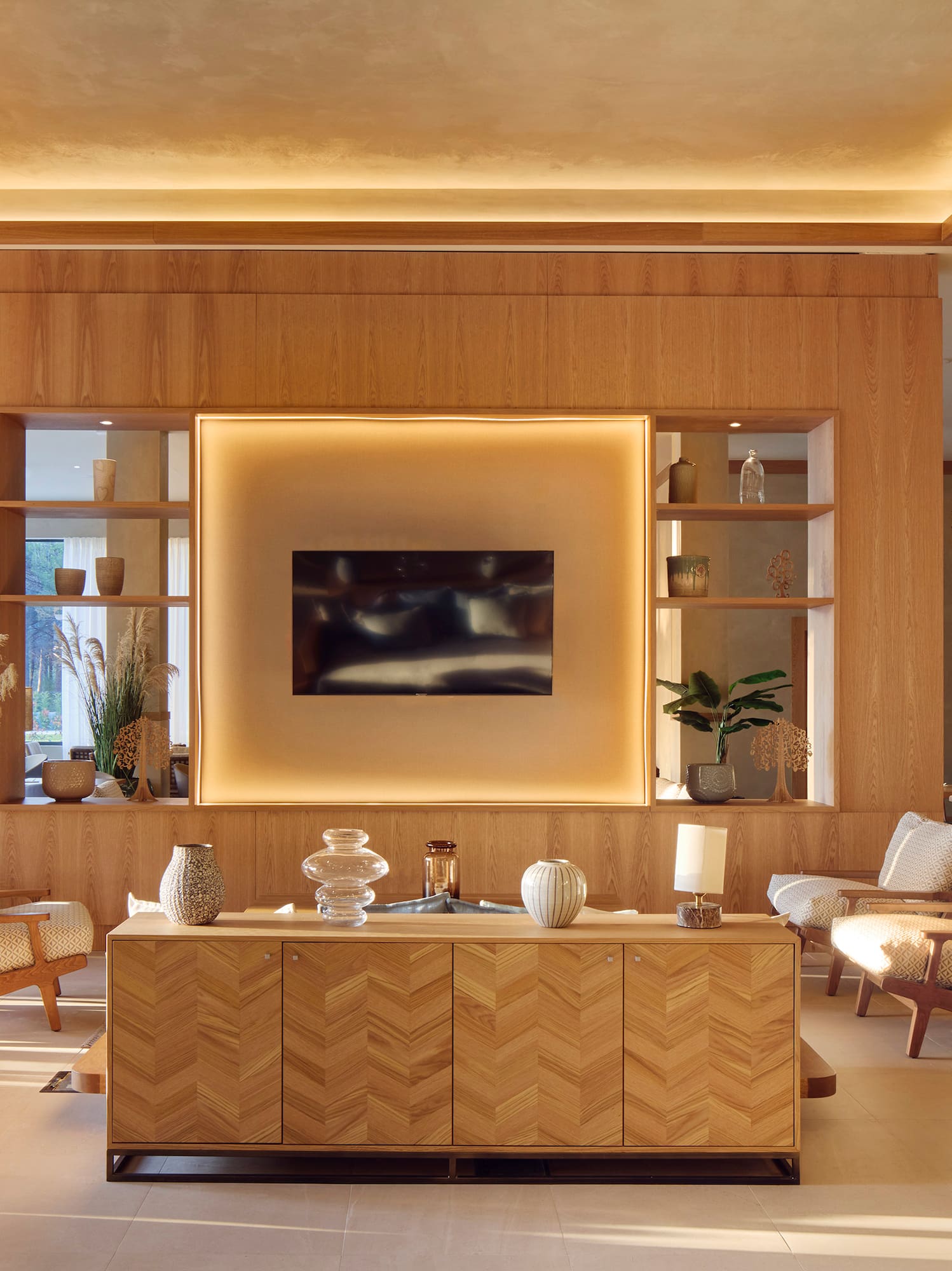 a room with a tv and chairs