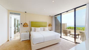 a bedroom with a glass door and a bed