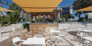 a white tables and chairs on a patio