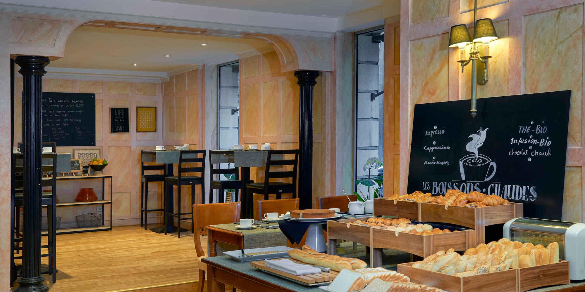 a room with a table of food and a blackboard