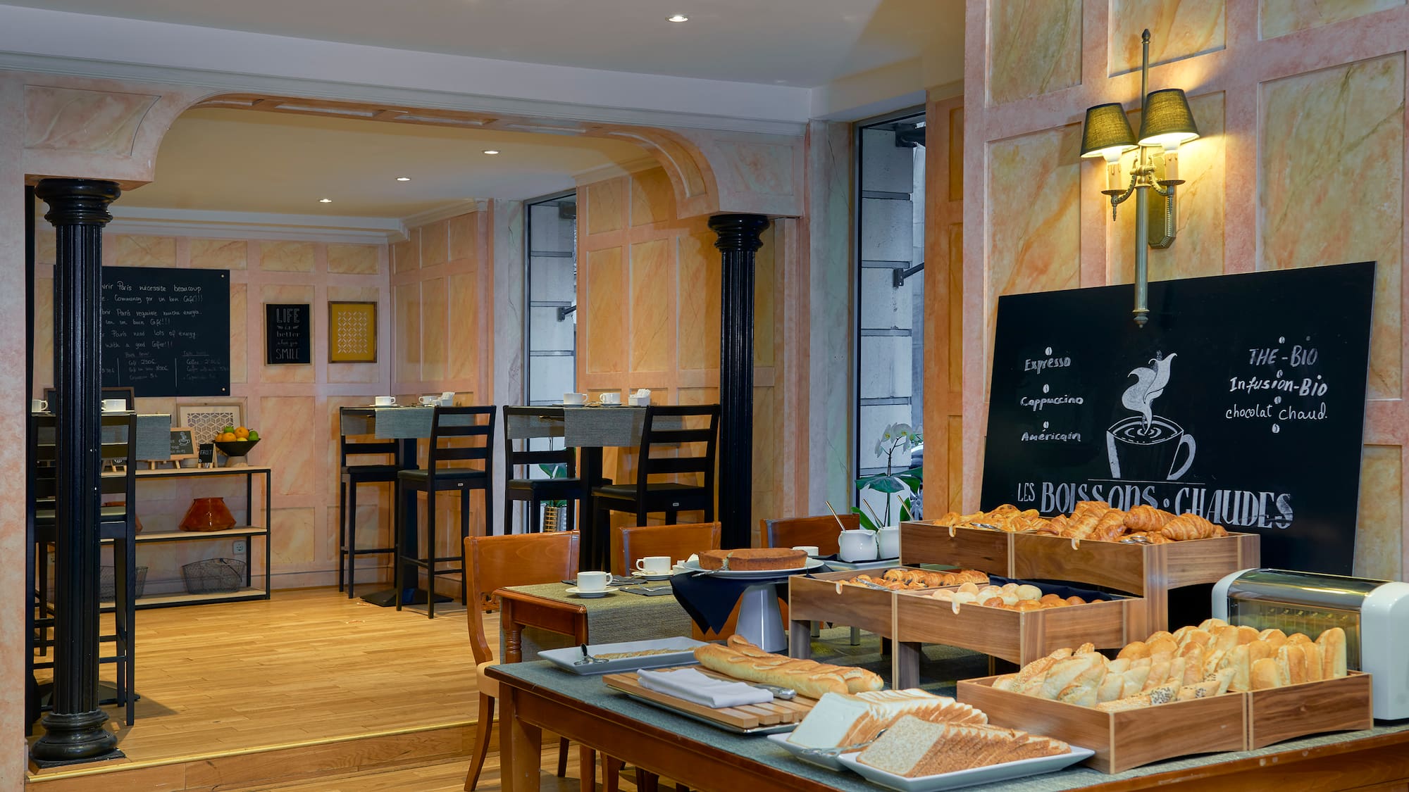 a room with a table of food and a blackboard