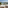 Balcony view of sunny beach resort with turquoise sea and swimming pool.