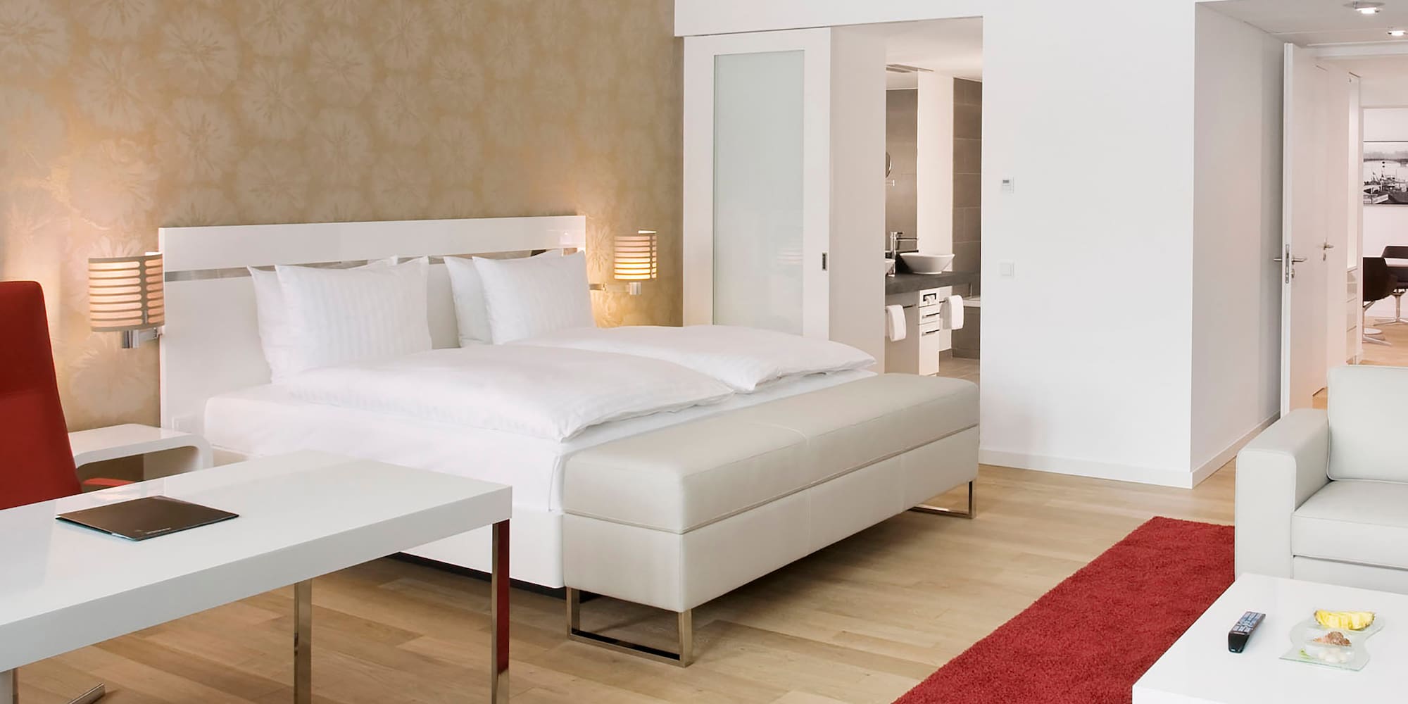 a bedroom with a bed and a red carpet