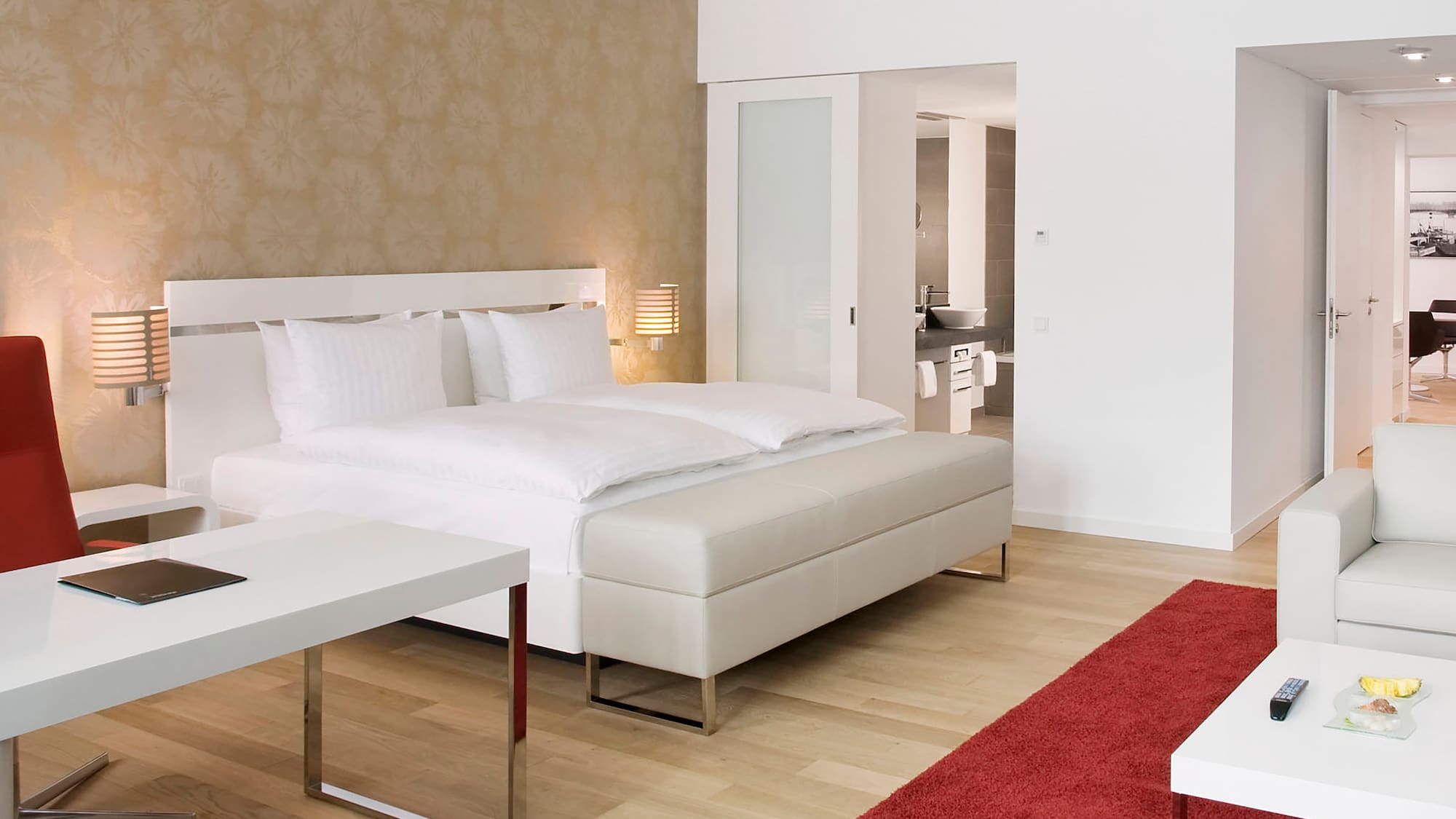 a bedroom with a bed and a red carpet