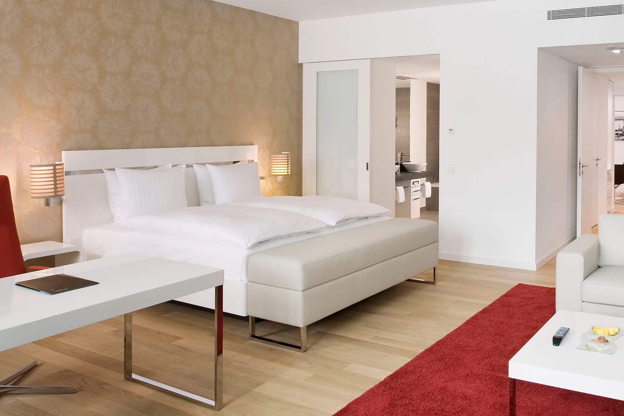a bedroom with a bed and a red carpet