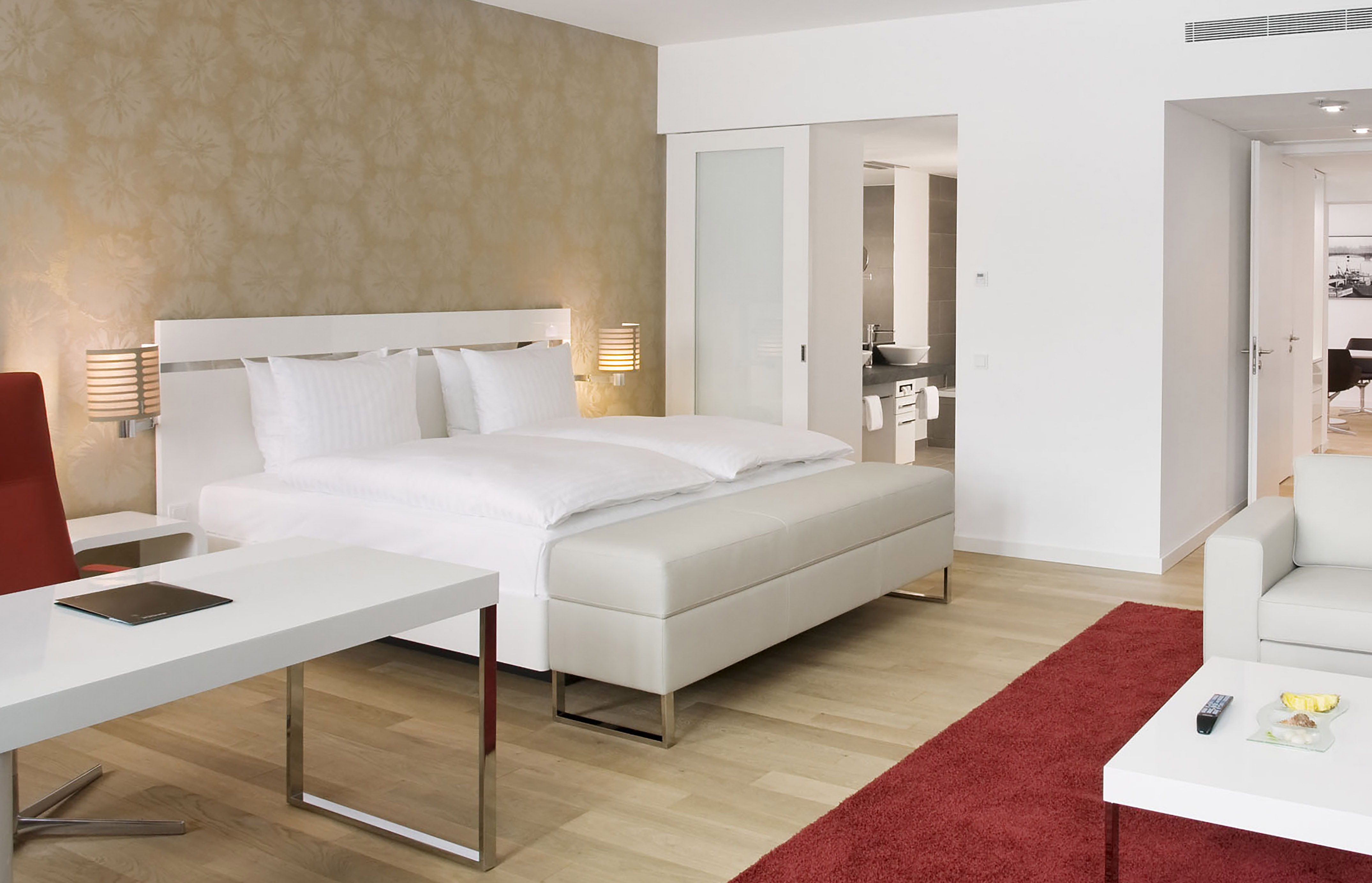 a bedroom with a bed and a red carpet