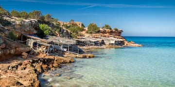 a rocky shore with a group of boats on it