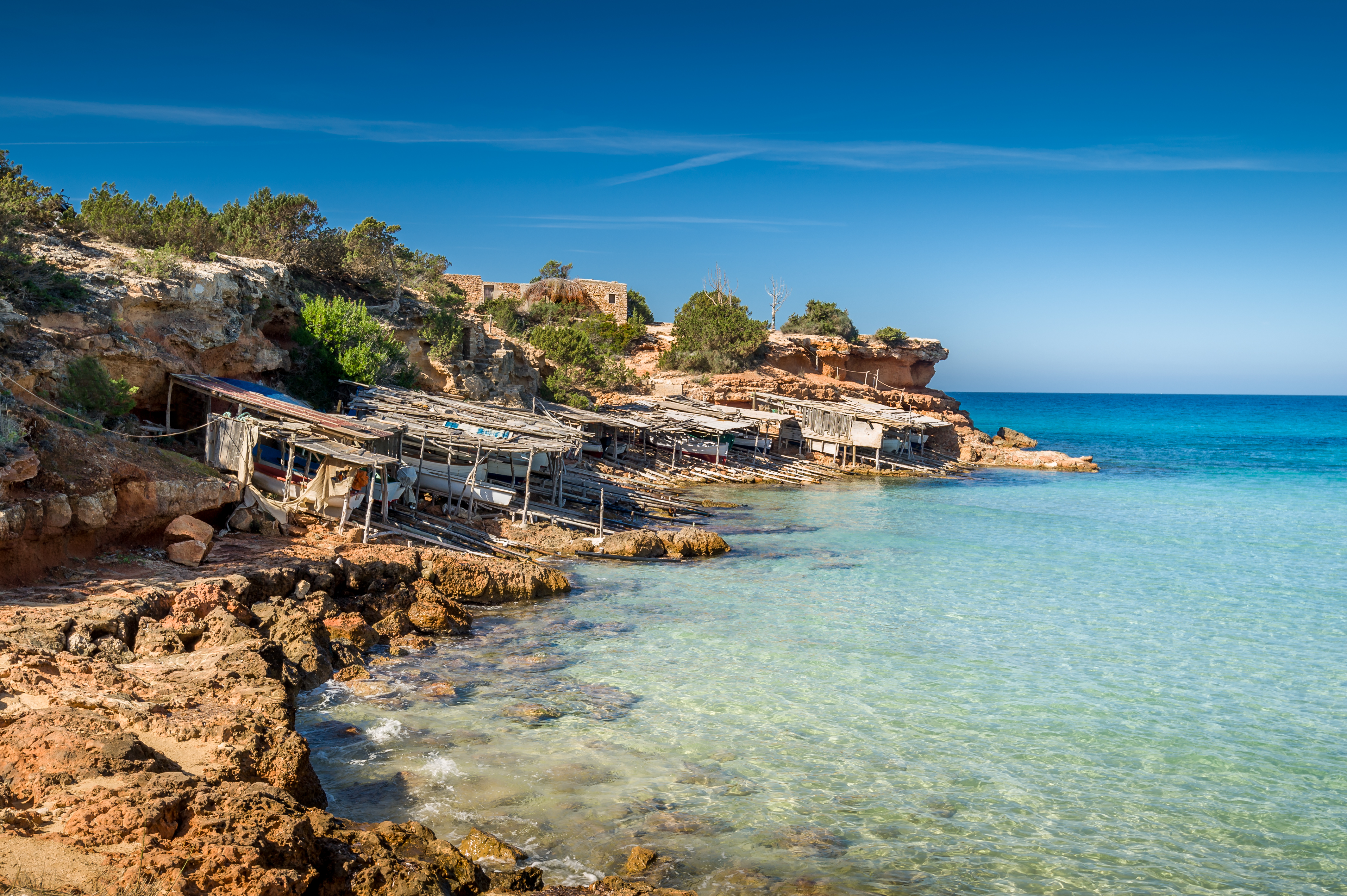 a rocky shore with a group of boats on it