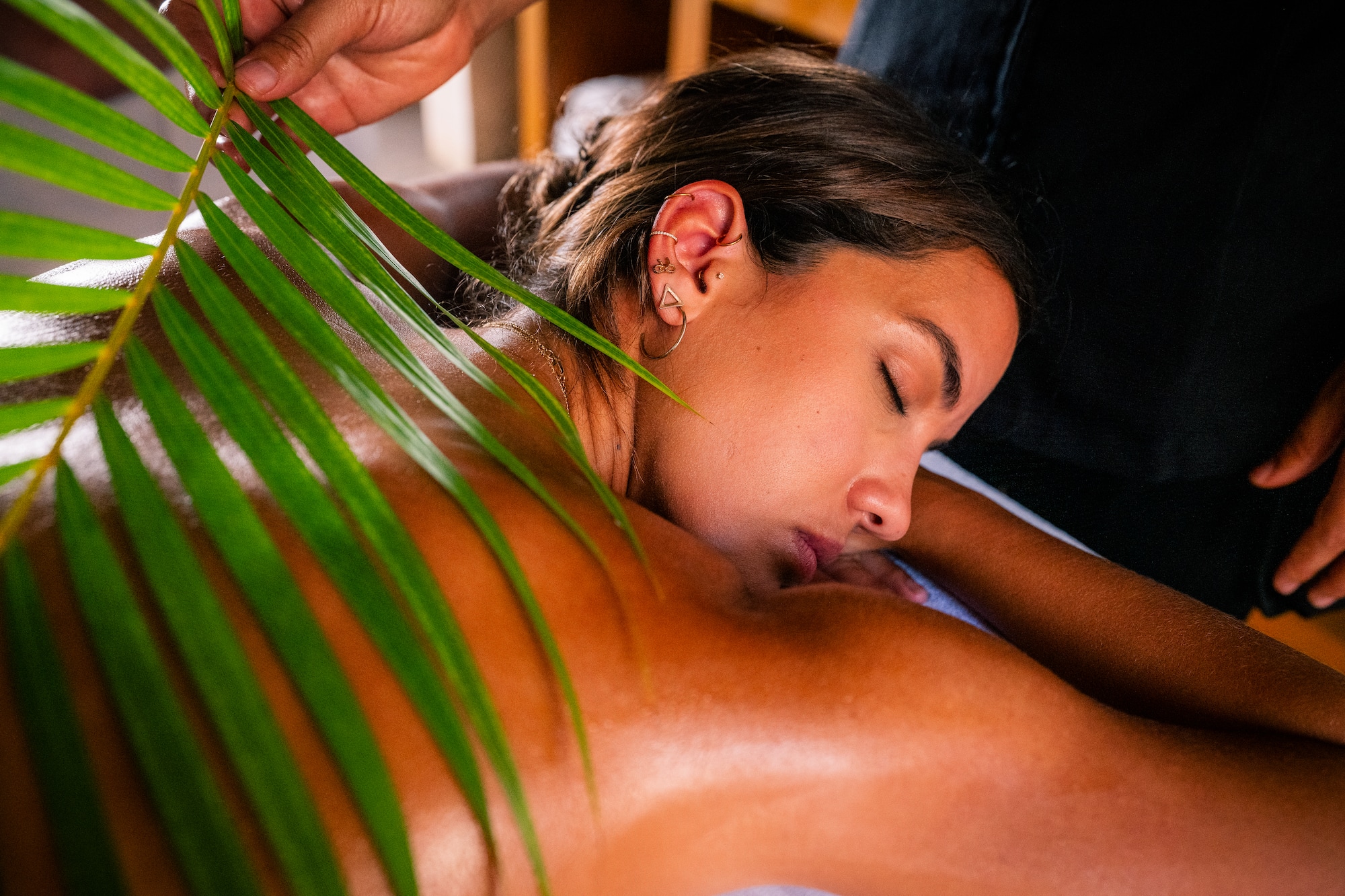 a woman lying down with her eyes closed