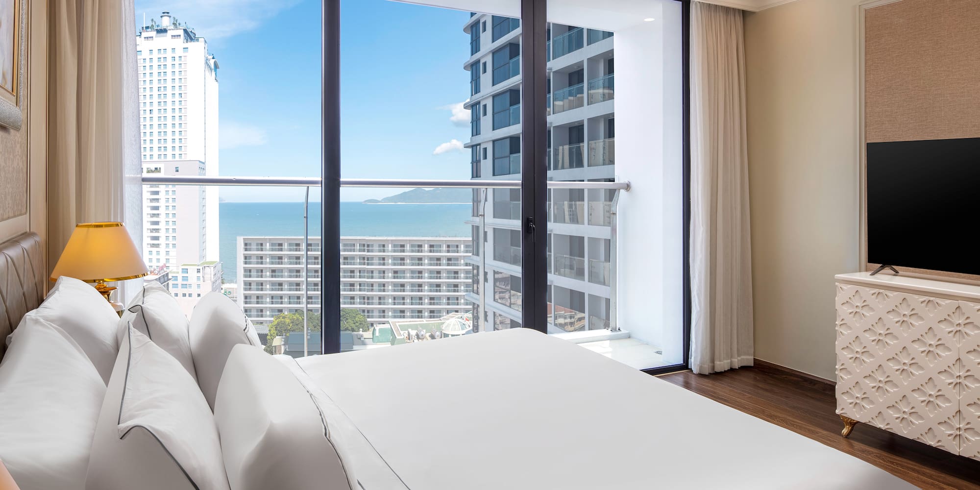 a bedroom with a large window overlooking a city