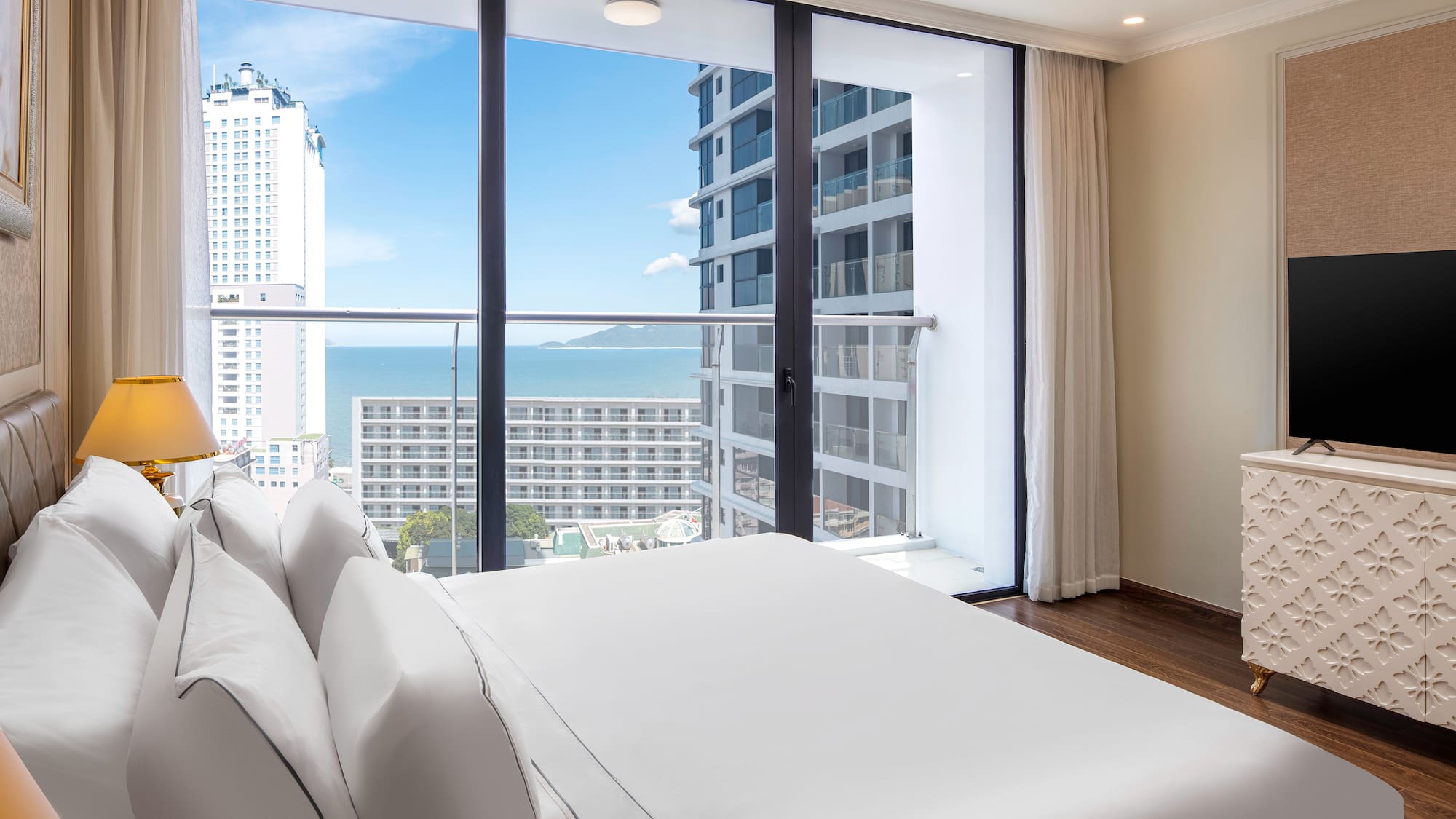 a bedroom with a large window overlooking a city