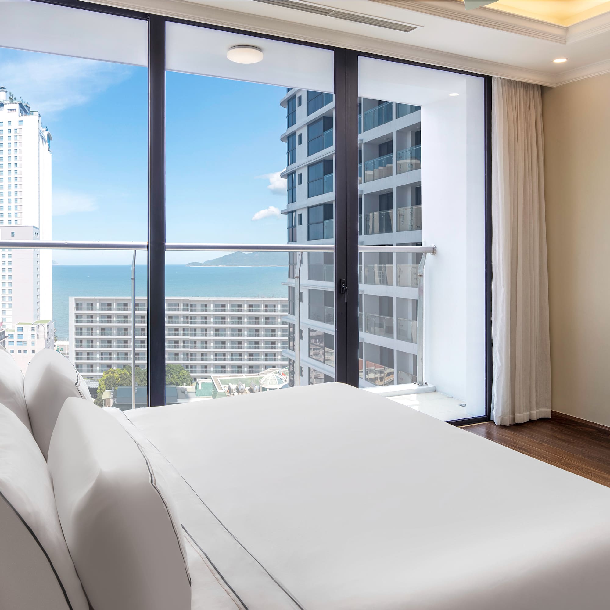 a bedroom with a large window overlooking a city