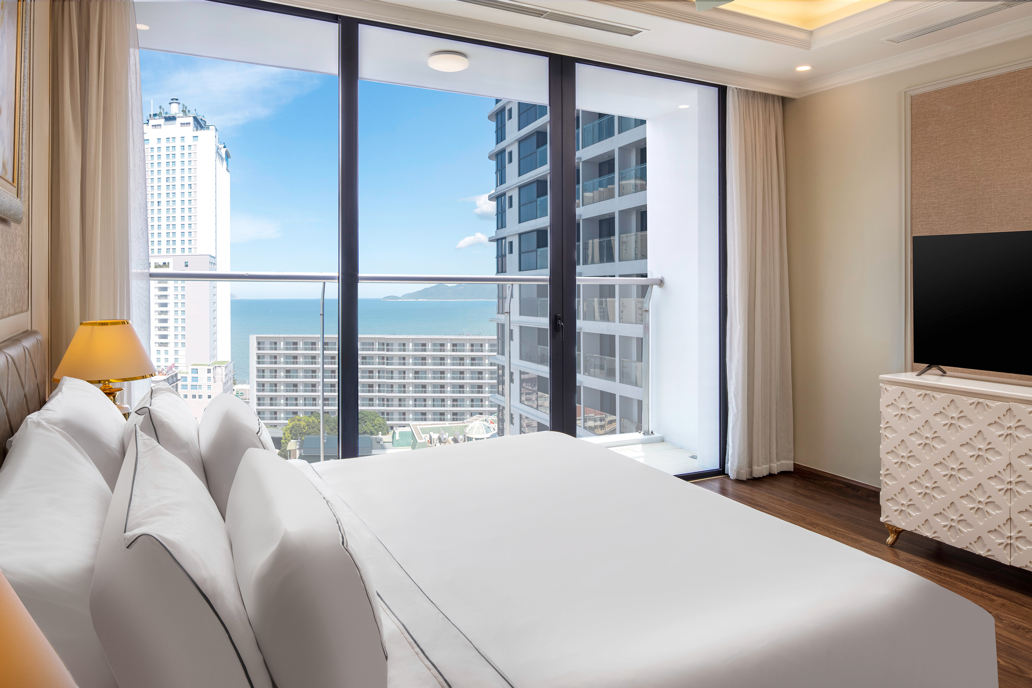 a bedroom with a large window overlooking a city