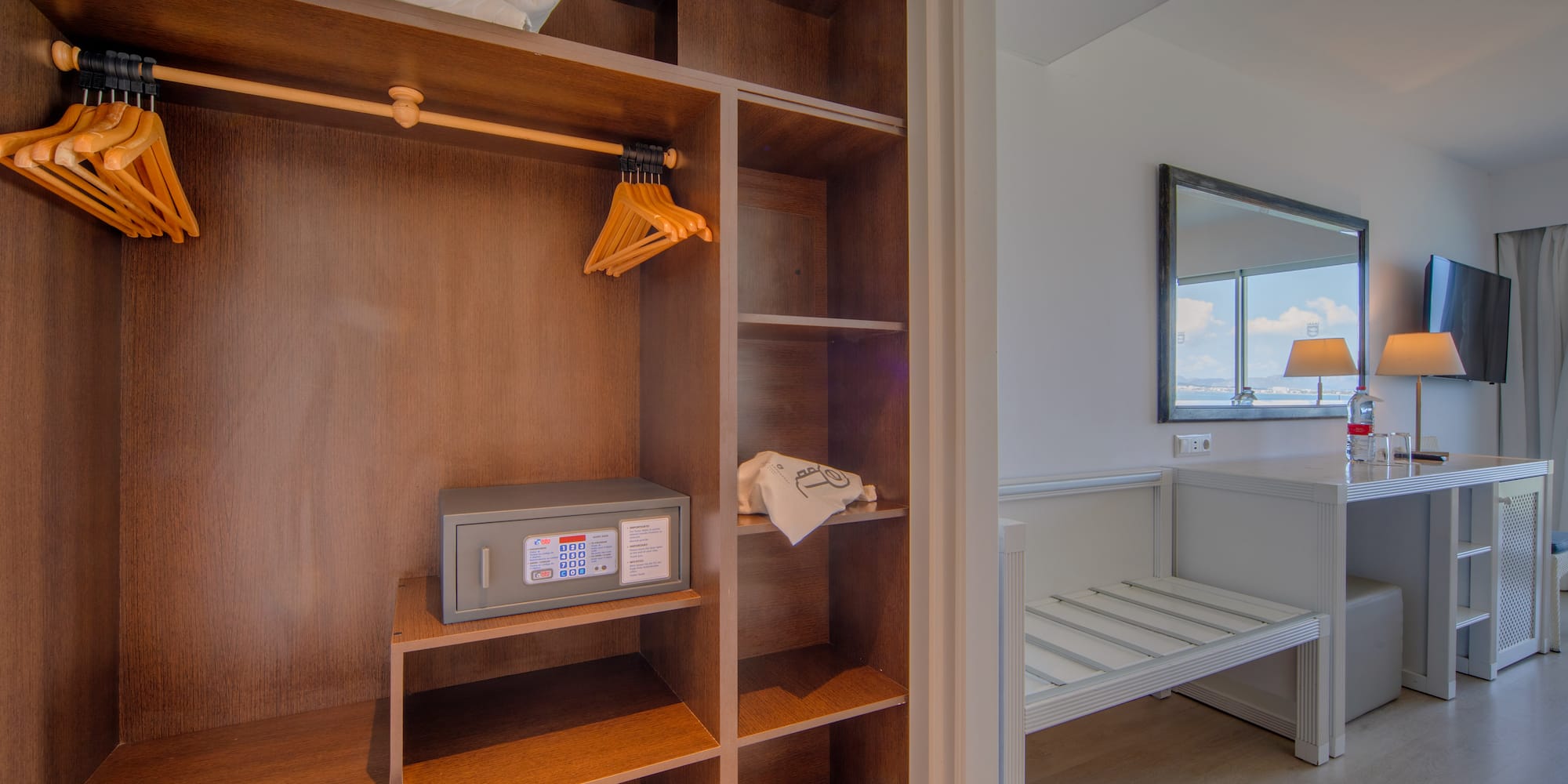 a closet with towels and a mirror
