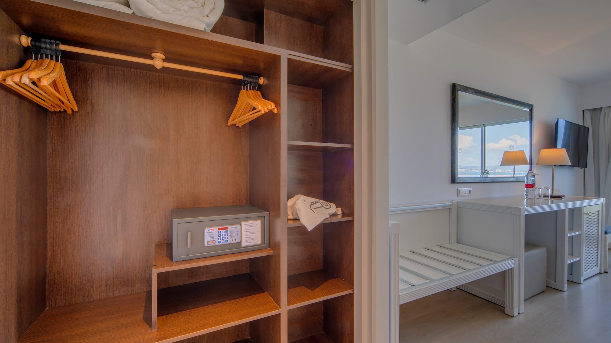 a closet with towels and a mirror