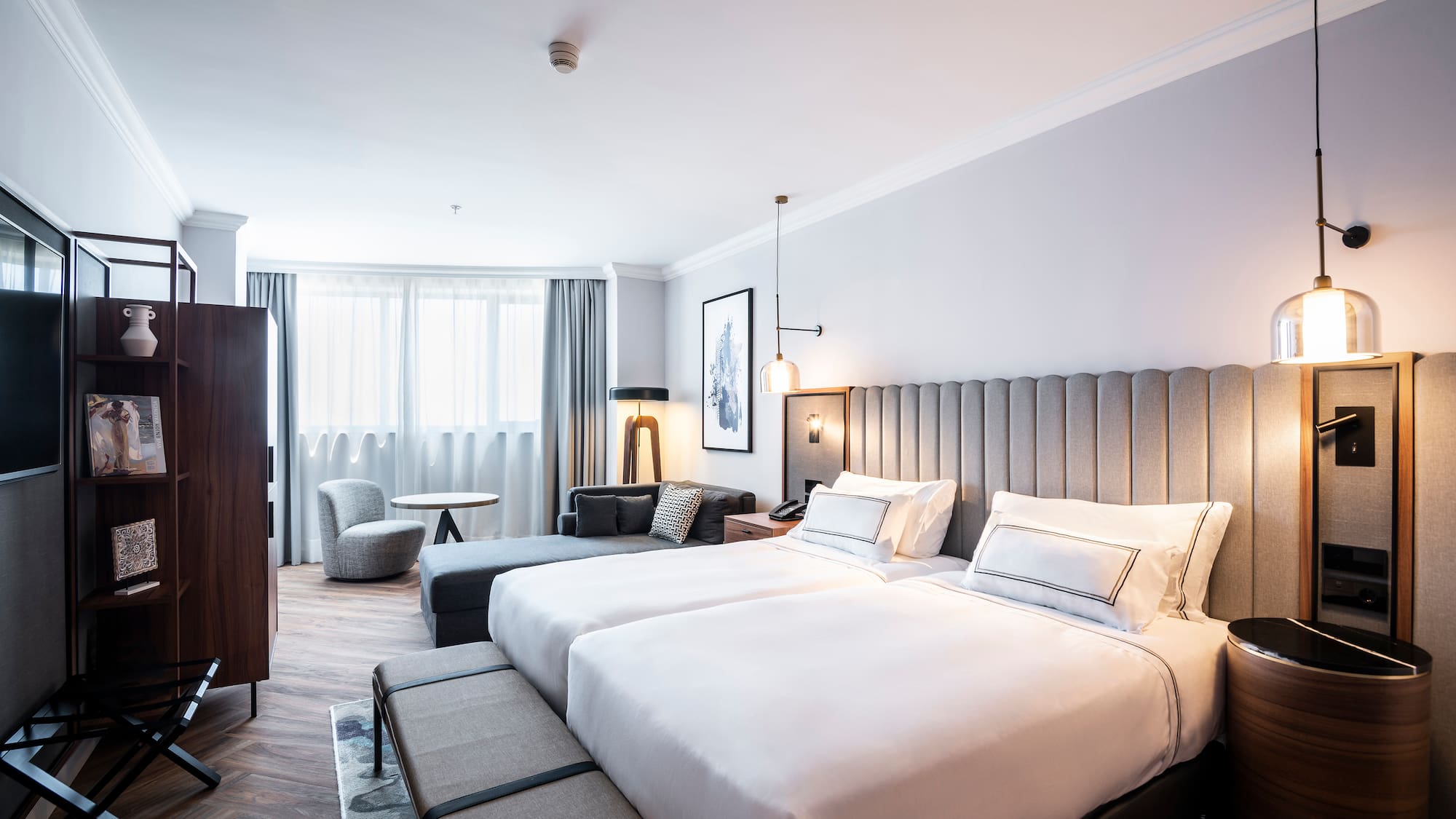 a room with two beds and a table