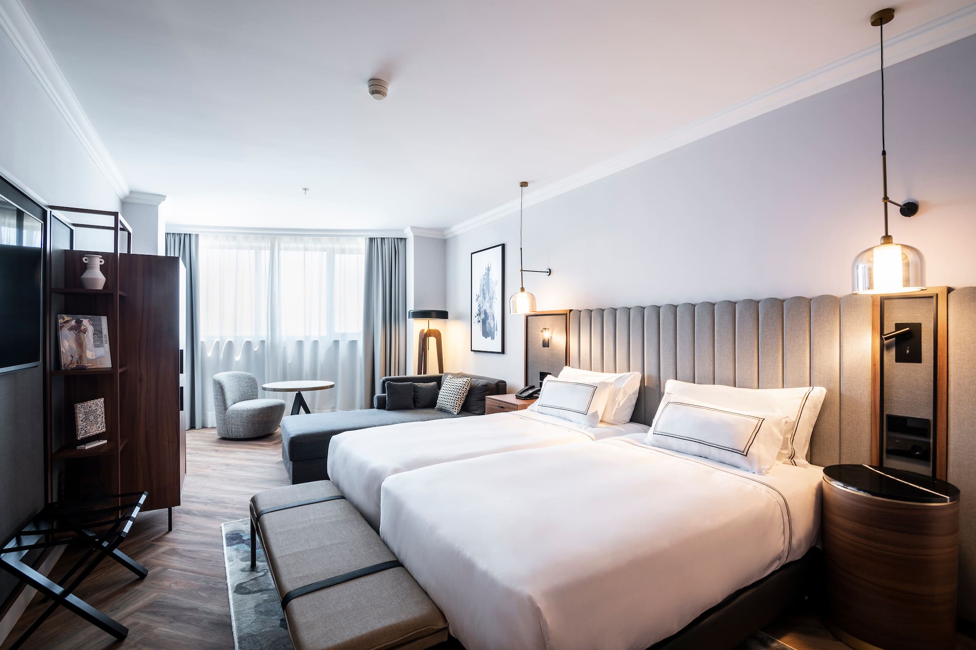 a room with two beds and a table