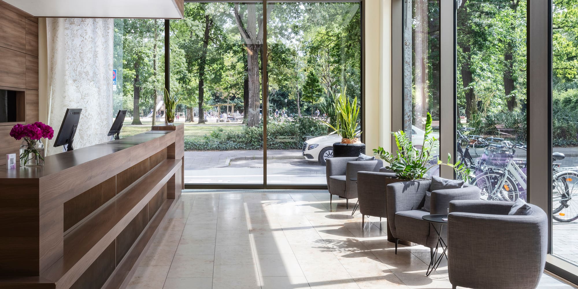 a lobby with a reception desk and chairs
