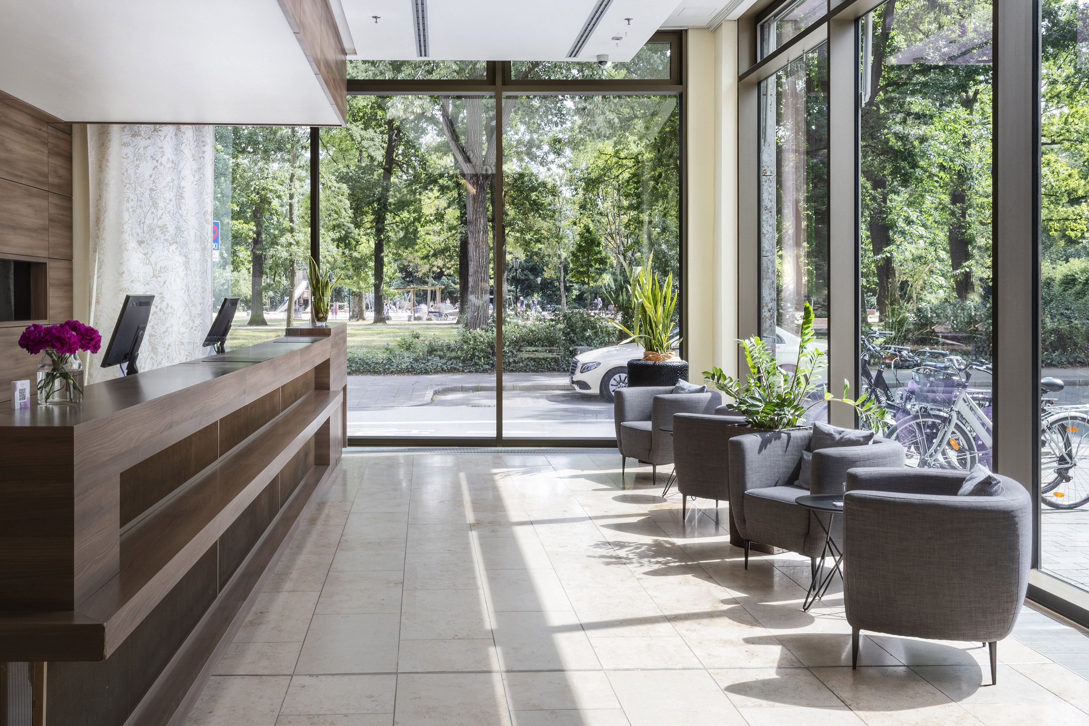a lobby with a reception desk and chairs