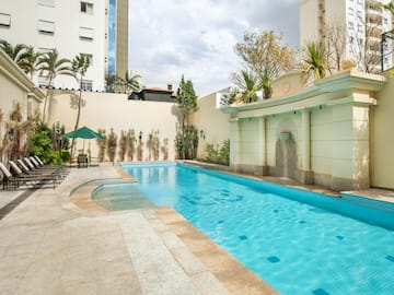 a swimming pool with a fountain in the middle of it