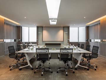 a conference room with a table and chairs