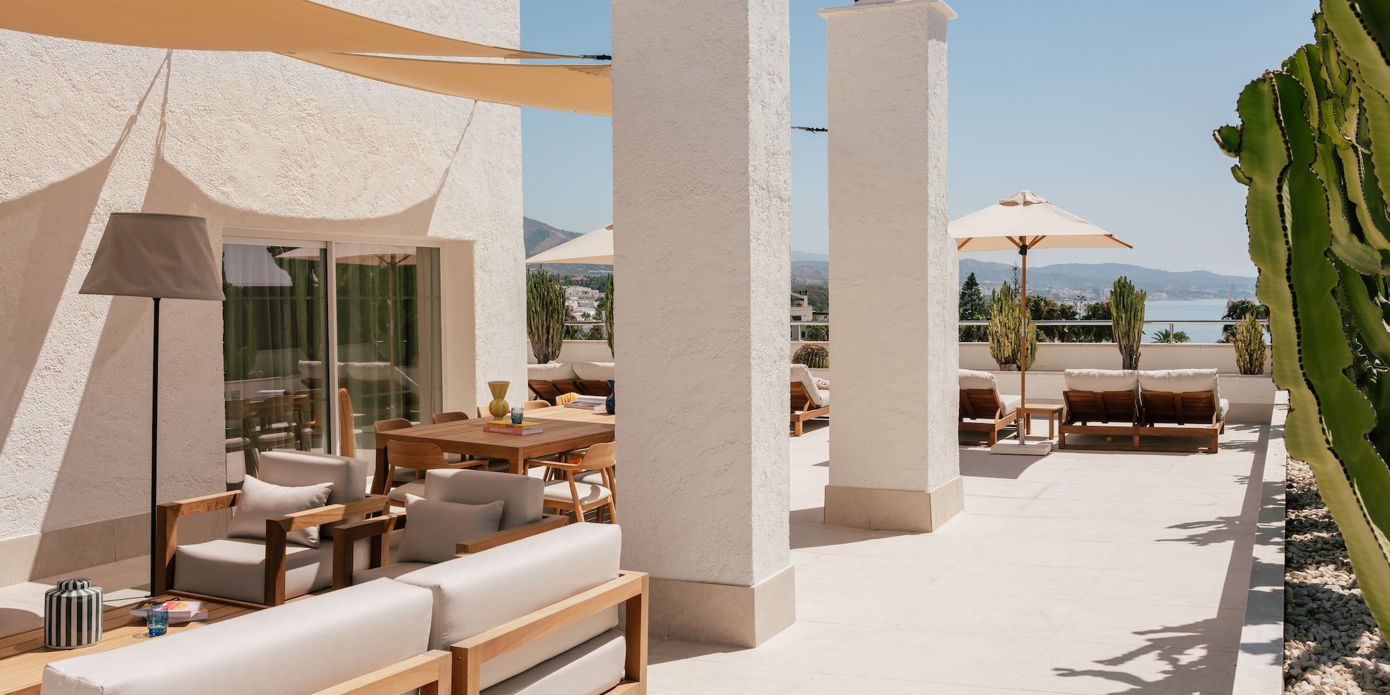 a patio with chairs and umbrellas
