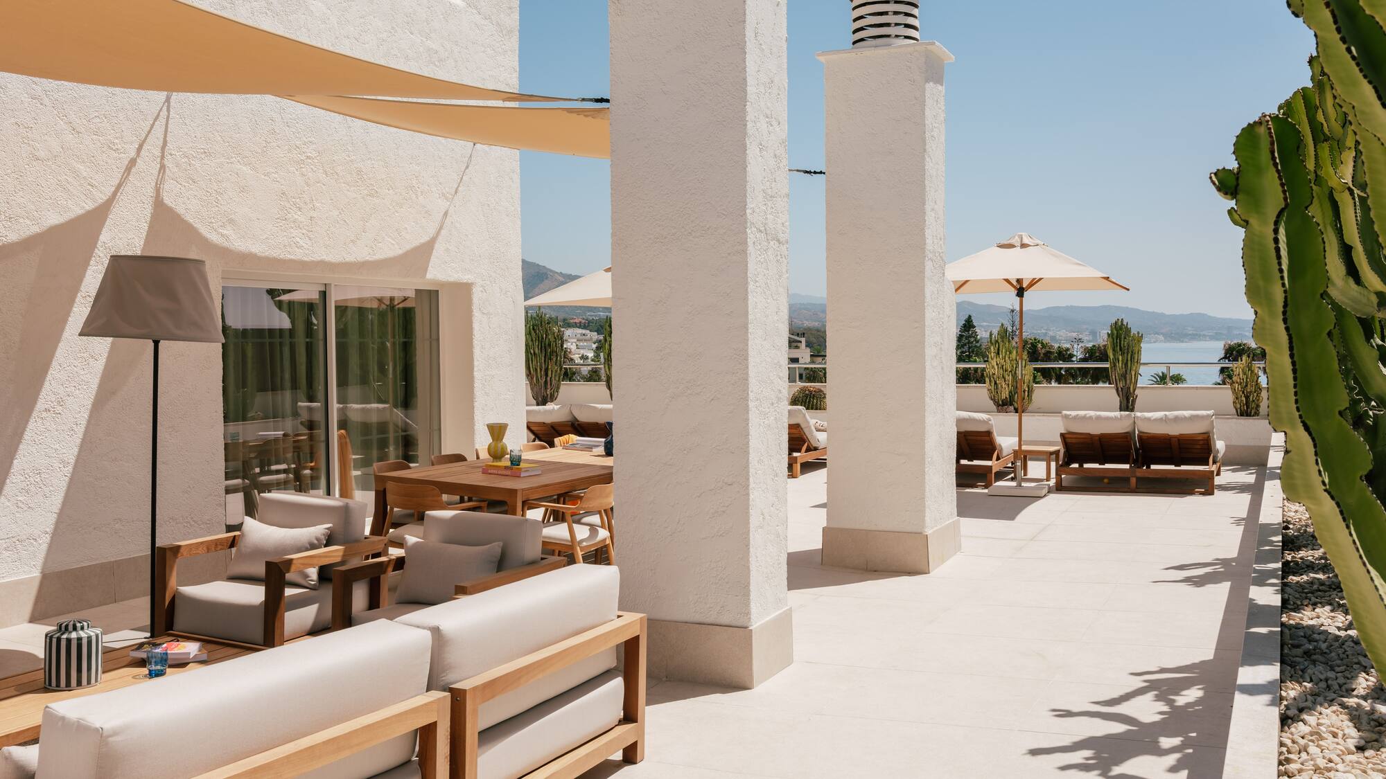 a patio with chairs and umbrellas